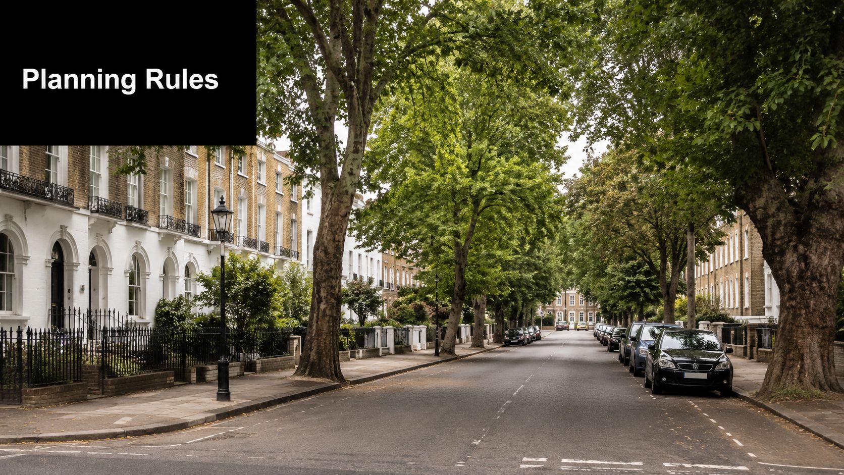 A quiet London street lined with mature trees and historic terraced houses during the daytime.
