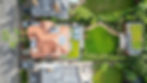 Aerial view of a house, terraces and planted garden