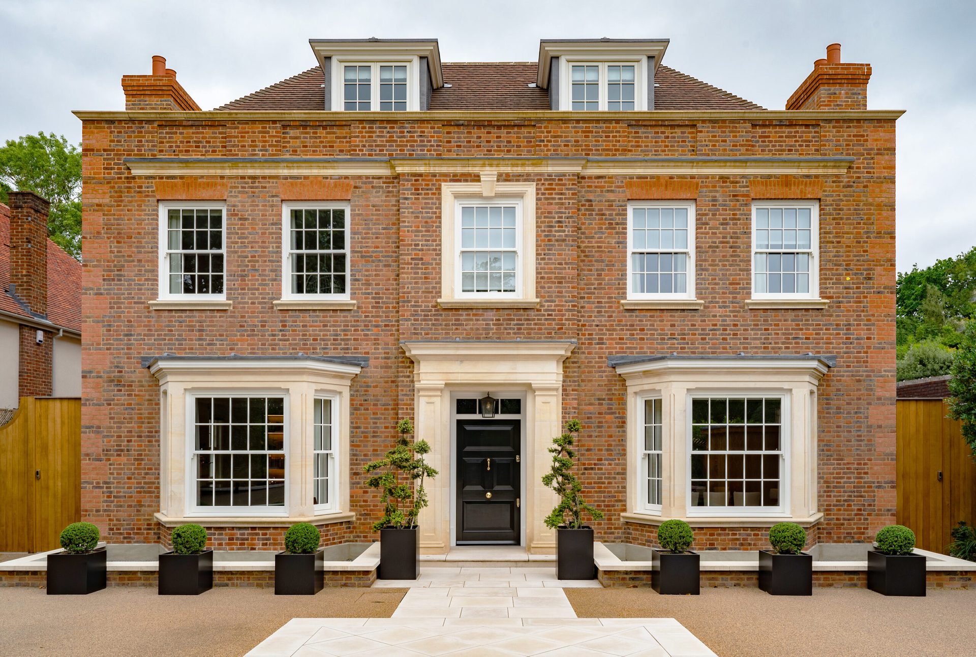 Georgian-style brick family home overlooking Wimbledon Park, with sash windows and a stone entrance surround