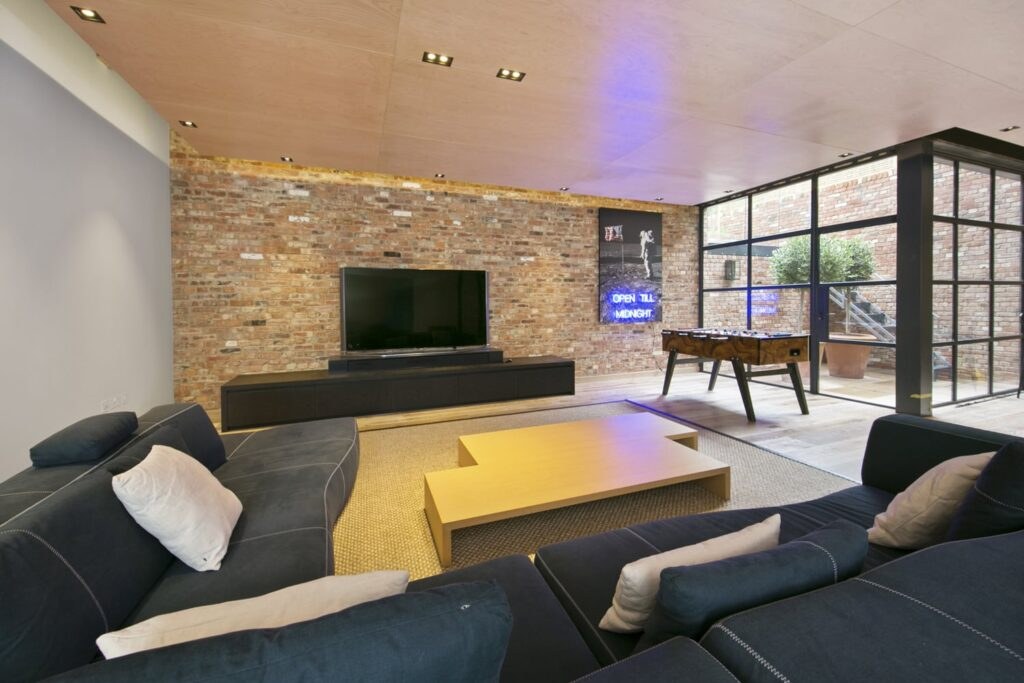 Cinema room with large screen and brick wall