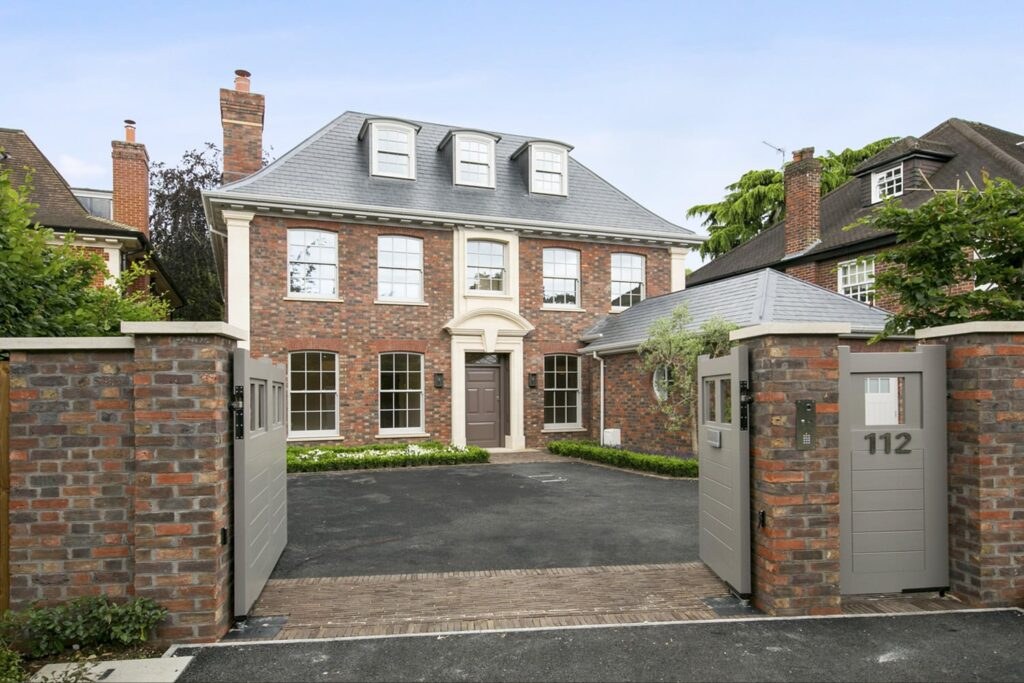 Front of a red-brick Wimbledon family home behind its garden gate