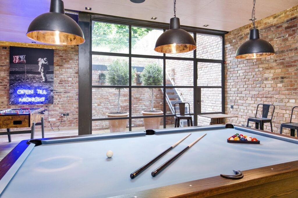Games room with pool table and exposed brick wall