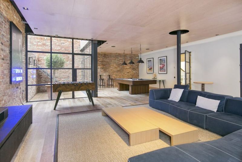 Living space with exposed brick wall and garden glazing